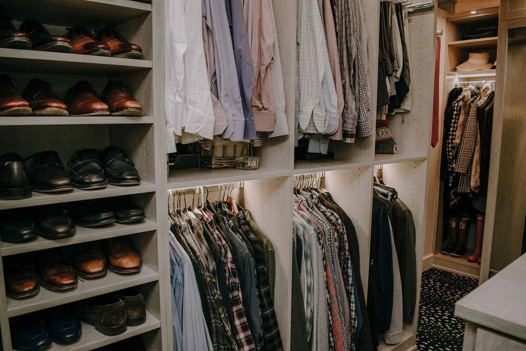 Sophisticated Men's Closet Men's closet, men's shoe shelves, double hanging, tie storage by California Closets Kansas City, KS.