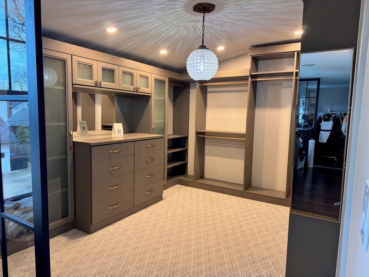 Walk In Closet Walk in closet with jewelry storage and a lot of hanging space for clothes.