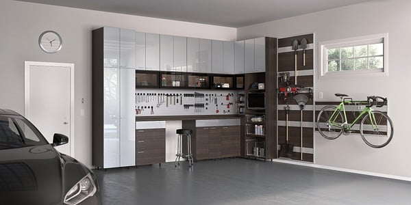 Garage storage with custom cabinets, drawers, workbench, and tool rack by California Closets Greater Detroit, Michigan.