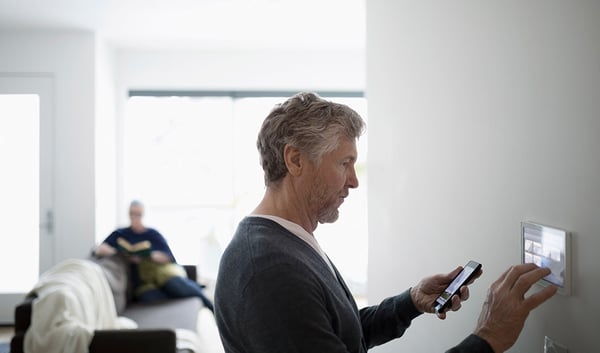 Man setting up smart technology at home.
