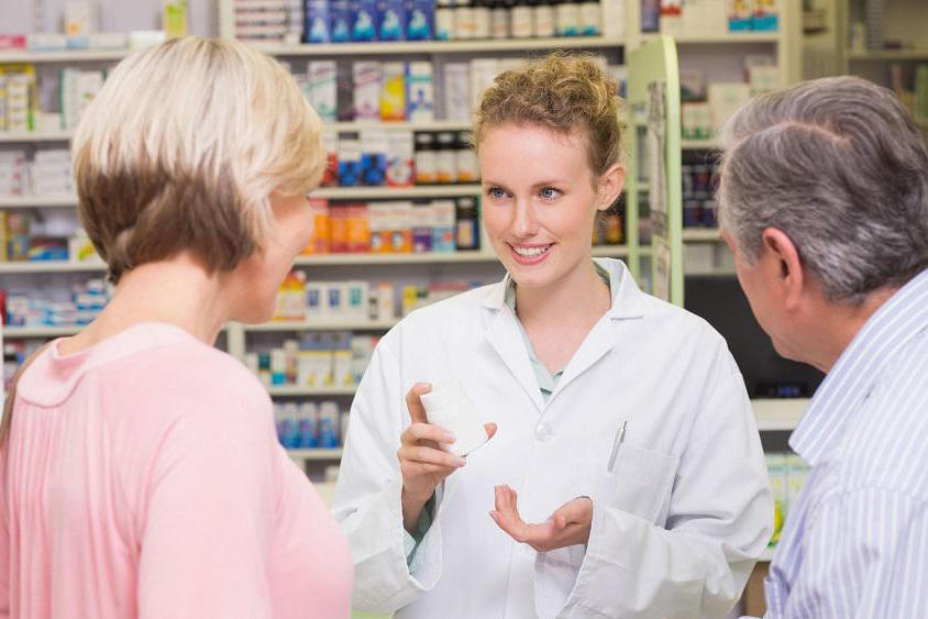 pharmacist talking to a man and a woman