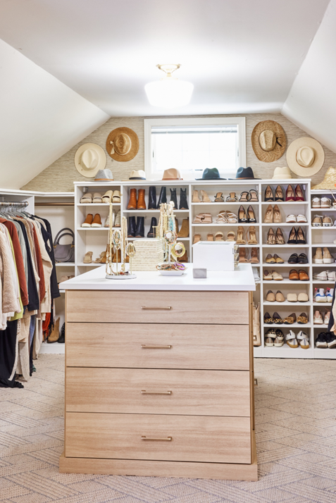 Sloped Ceiling Walk-in Closet Sloped ceiling walk-in closet with center island, shoe shelves, and hanging sections.