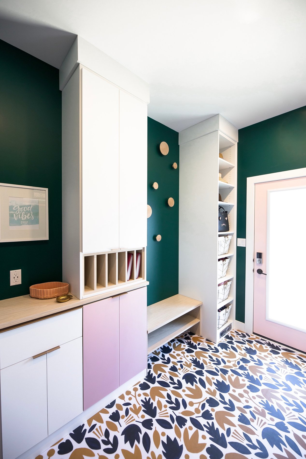 Modern and Unique Mudroom Unique mudroom system design in a white finish with pink door front and a wood bench and countertop. Add vertical shelves for sorting mail.