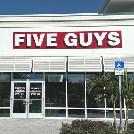 Exterior photograph of the Five Guys restaurant in Parrish, Florida.