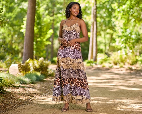 Woman is wearing an animal print maxi dress.