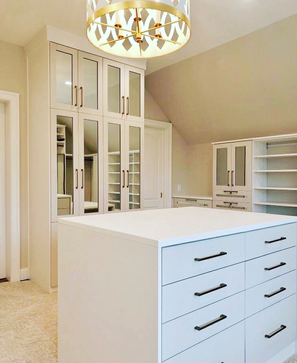 Walk-In Closet with Mirrored Doors and Custom Island