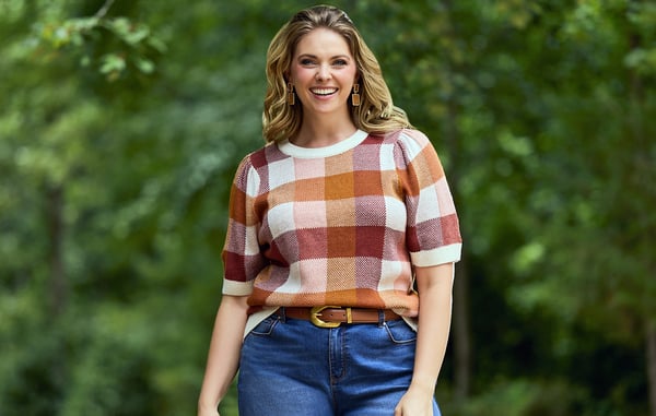 Woman is wearing a plus size plaid sweater