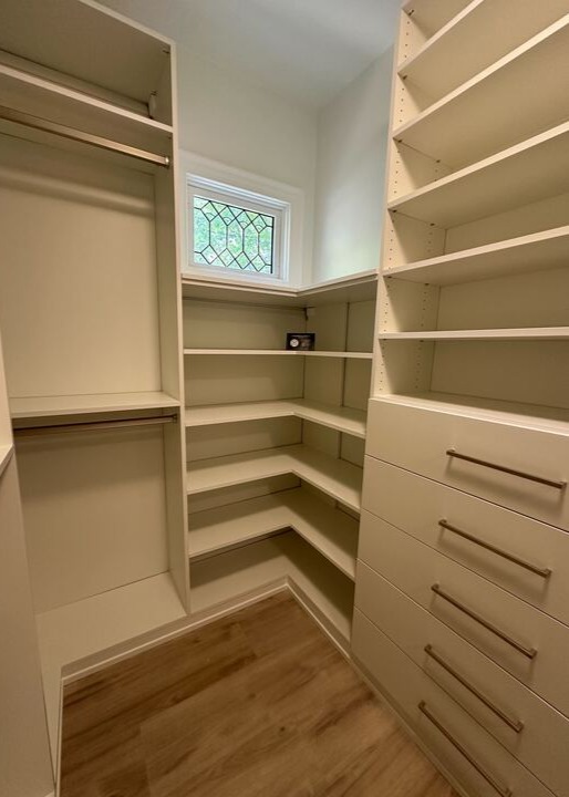 White walk-in closet with center island Greensboro - Custom closets - walk-in closet with wrap-around corner shelves and drawers