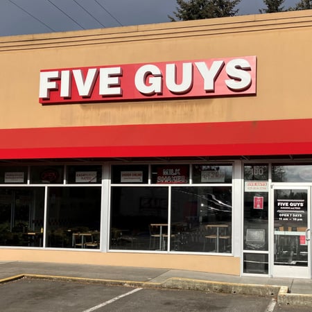 Exterior photograph of the Five Guys restaurant at 11220 NE 124th Street in Kirkland, Washington.