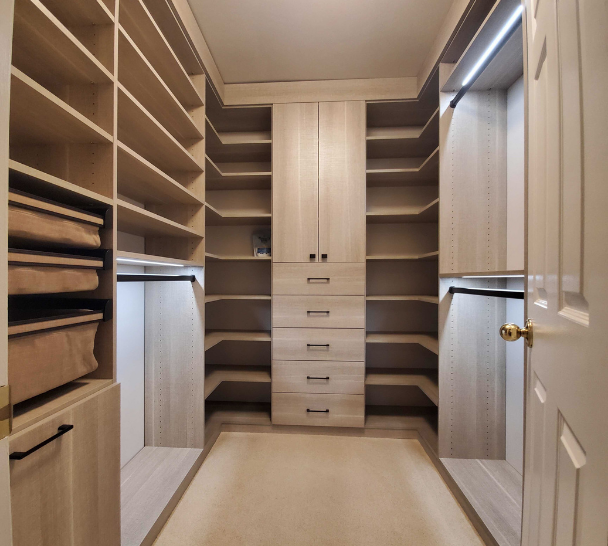 Custom Walk-In Closet Custom walk-in closet with shelving, drawers, bins, and hanging space.