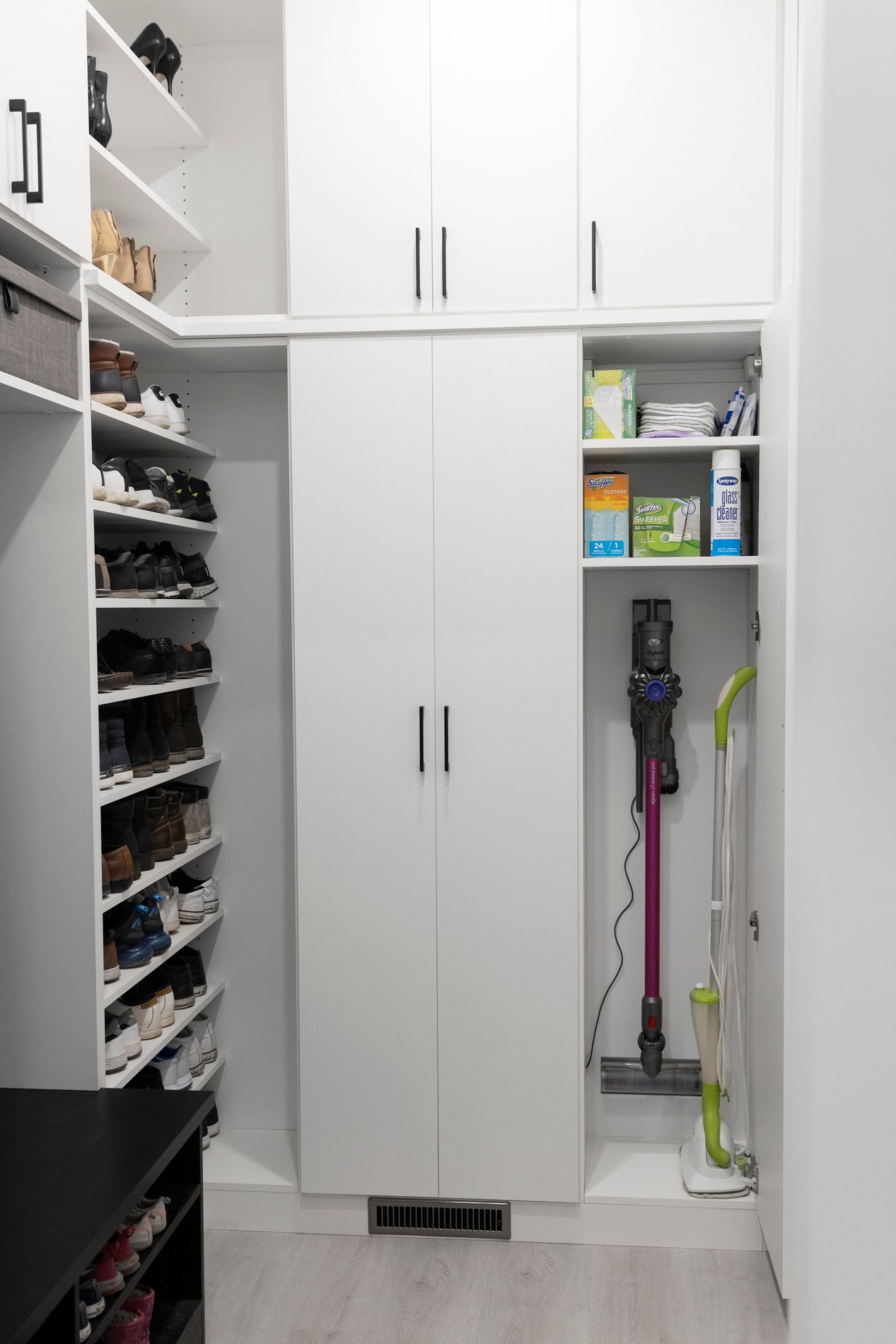 Mudroom and Utility White mudroom and utility storage with black hardware.