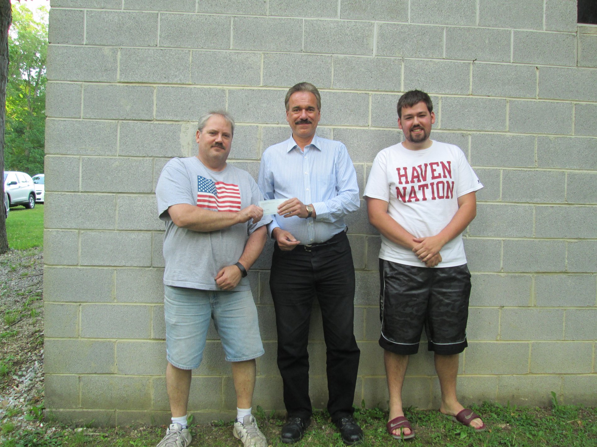 Duaine Detrick (Allstate agency owner) presents a $1,000 Allstate Foundation Hands in the Community Grant check as a volunteer to Portage Area Summerfest, Inc.