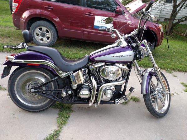 A photo of a motorcycle parked in a driveway.
