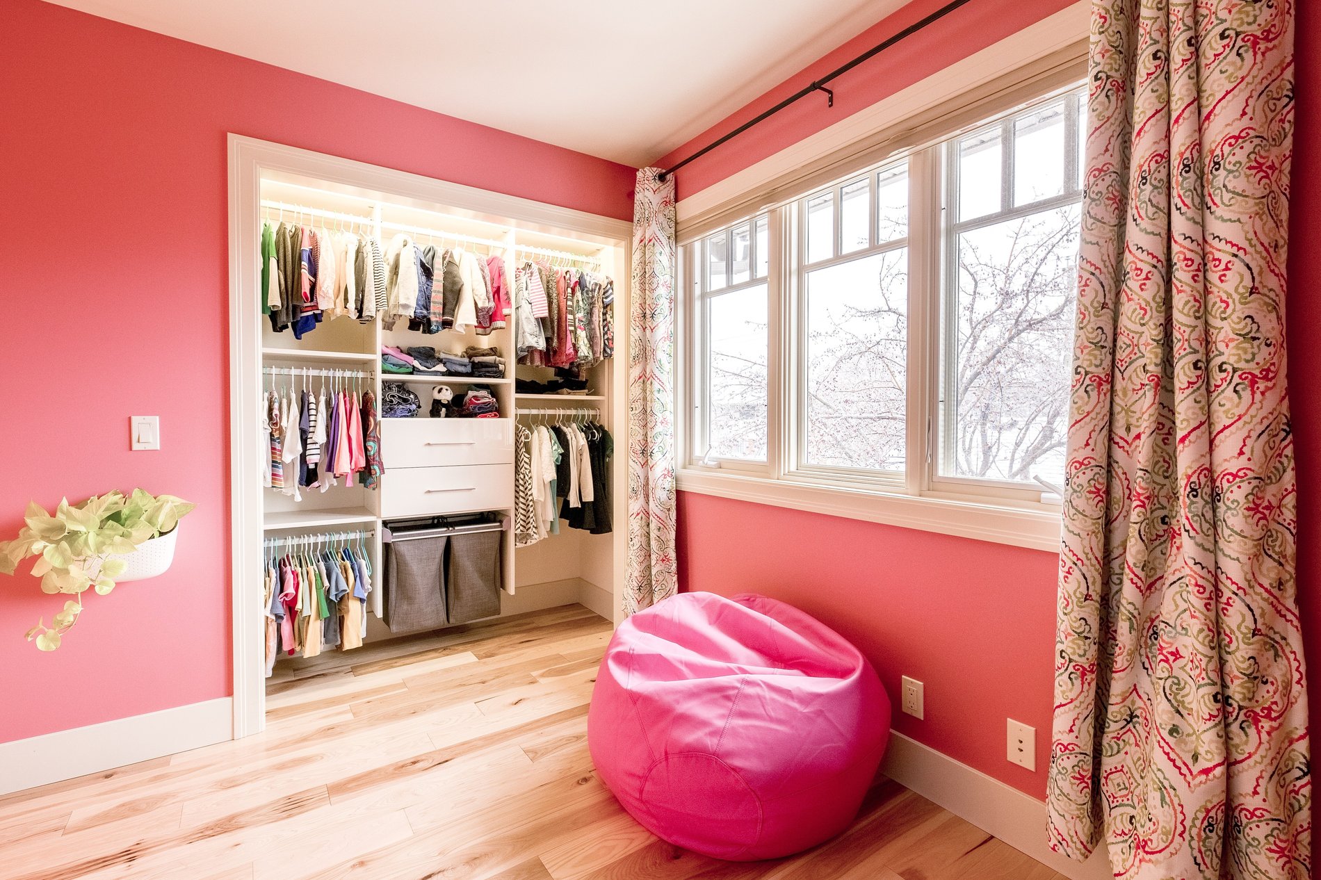 Kid's Reach-In Closet Kid's closet with hanging space, drawer storage, and pull-out hampers by California Closets Edmonton, Alberta.