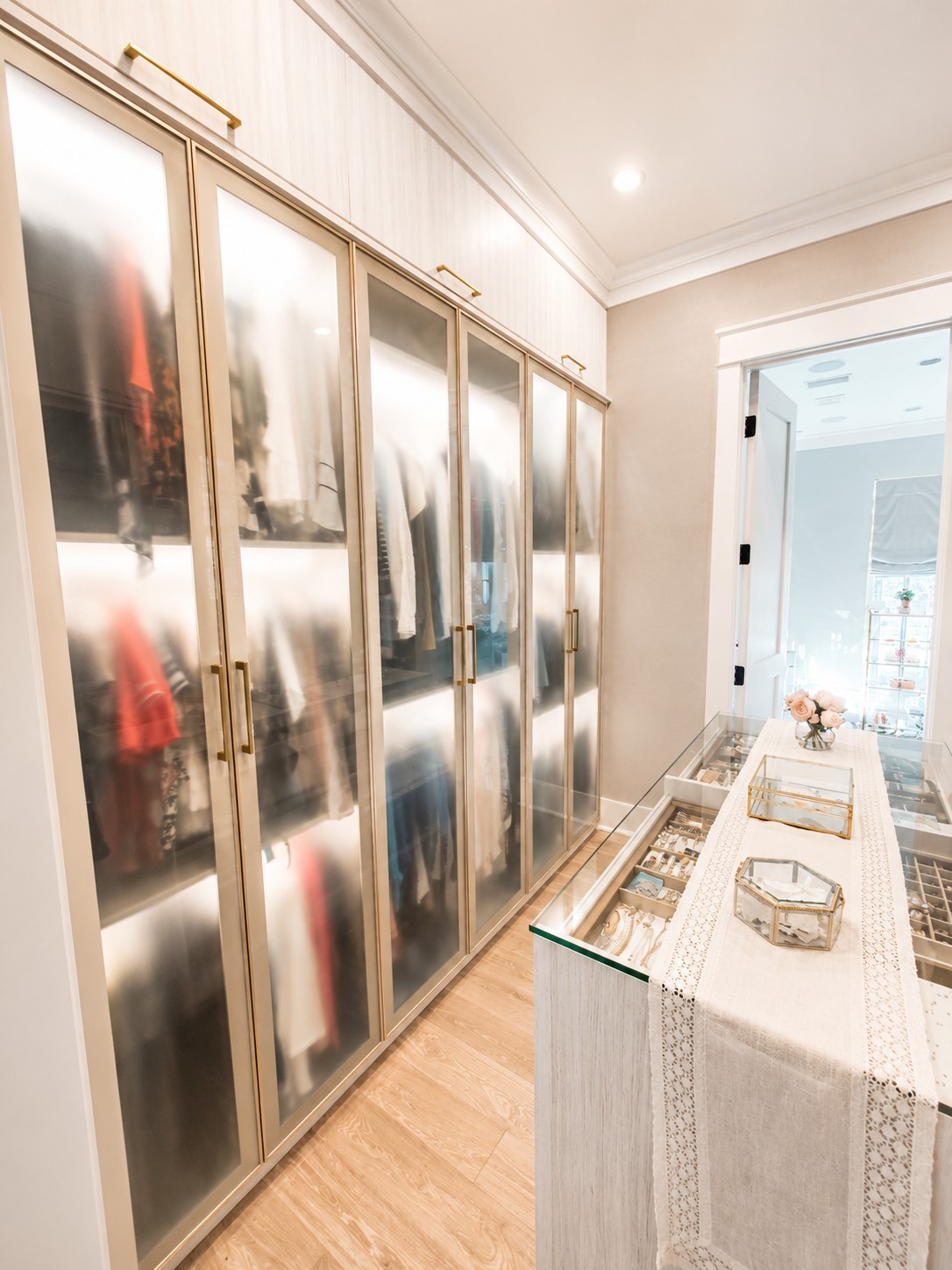 Walk-in Closet Primary Walk-in Closet with center island and glass doors.