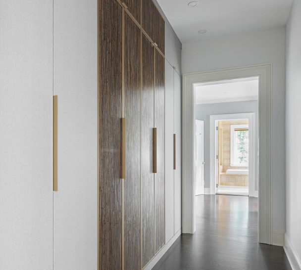 Custom Beige and Brown Wardrobe California Closets Westchester NY Two Toned White and Bronze Resin Doors Closed Cabinetry with Gold Handles