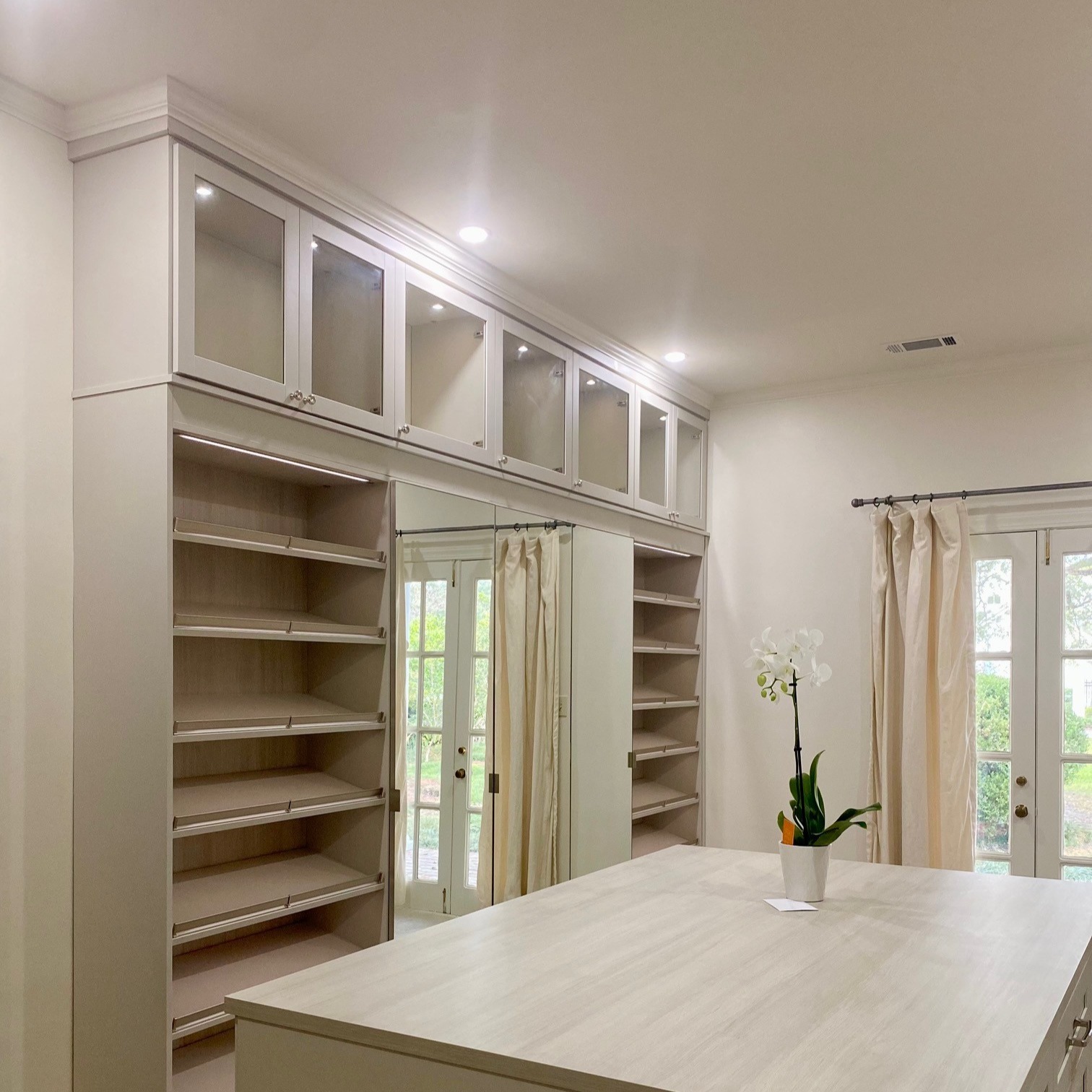 Walk-in Closet Light gray walk-in closet organization with island and shoe shelving California Closets New Orleans & Gulf Coast