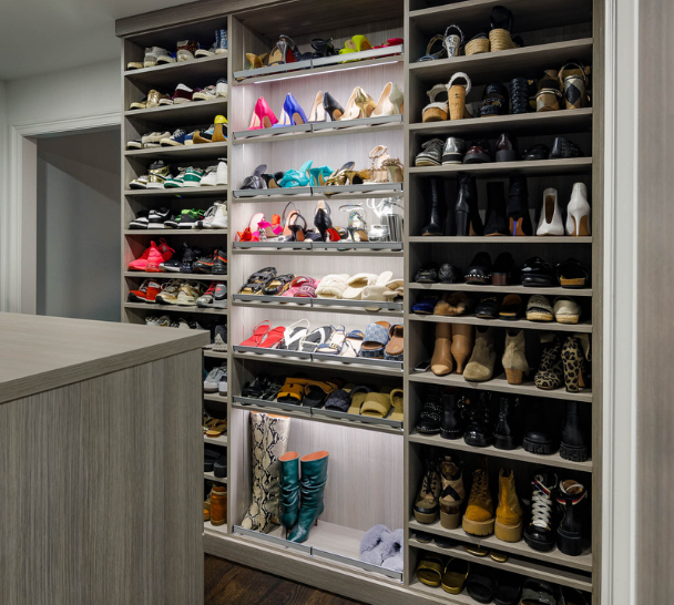 Gray Luxury Shoe Wall Img 4 California Closets Westchester County NY Gray Walk-in Closet Full Room Dressing Room with Double Hanging Dedicated Shoe Wall with Lighting and a Center Island with Black Leather Jewelry Drawers