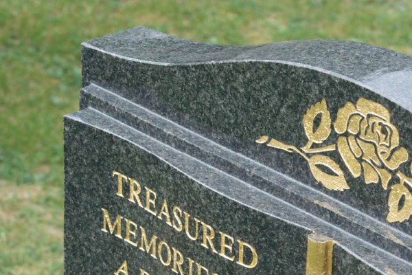 Granite headstone with a polished finish and gold leaf inscription