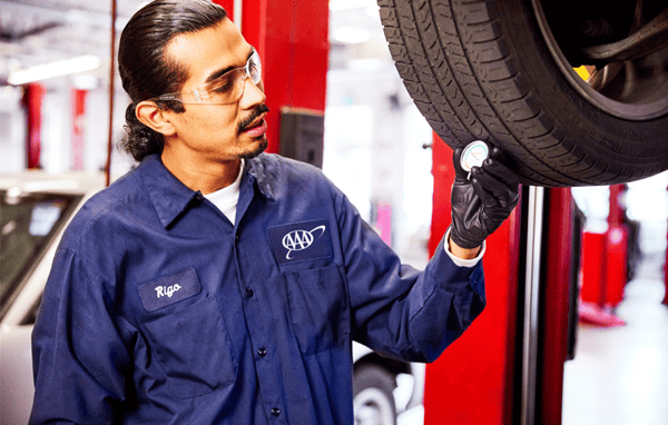 AAA Auto repair mechanic inspects car