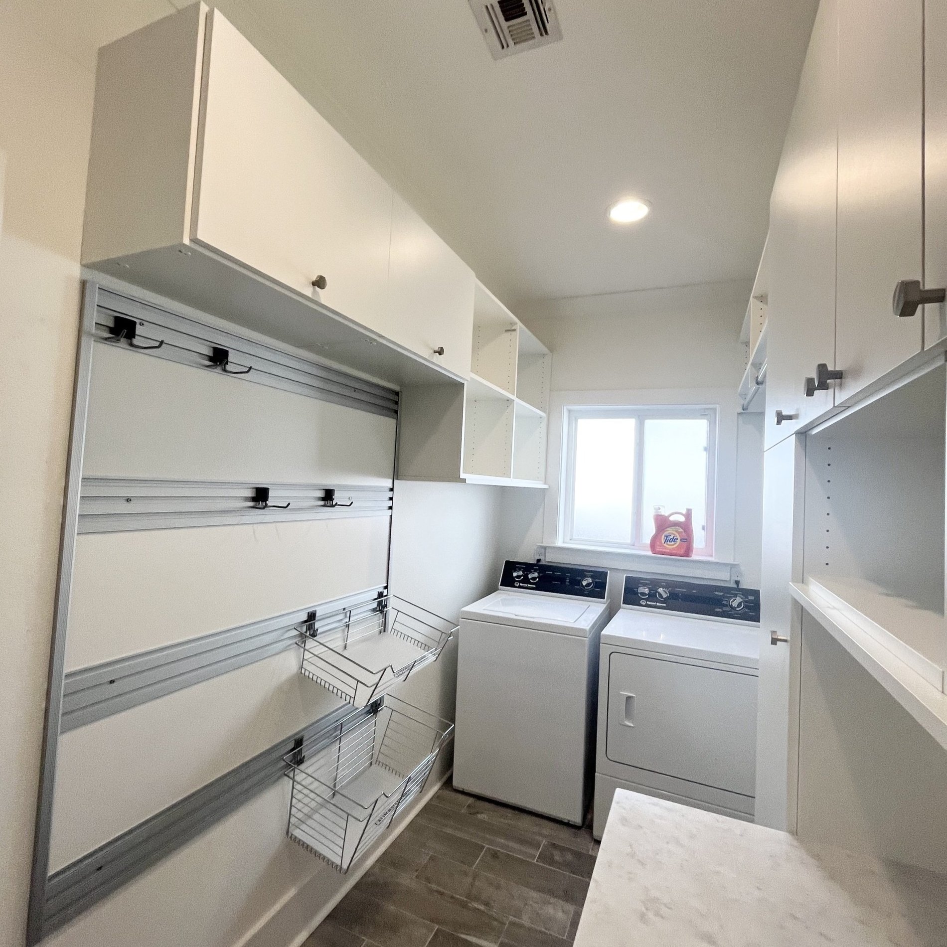 Laundry Room Storage Custom cabinets for laundry room with hamper baskets California Closets New Orleans & Gulf Coast in Metairie, Louisiana