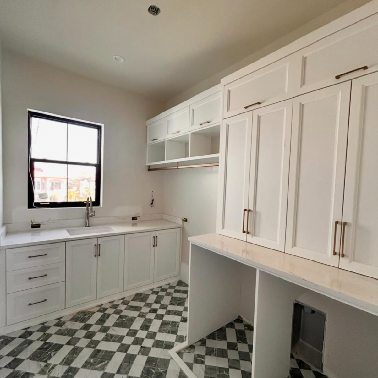 Refined Laundry Room with Dove Finish and Gold Accents Laundry room with Dove finish, gold hardware, and Lexington modern mitered doors.