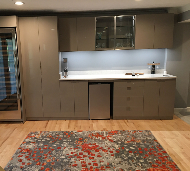 Custom Entertainment Bar Custom bar with cabinets, drawers, shelving, and a countertop.