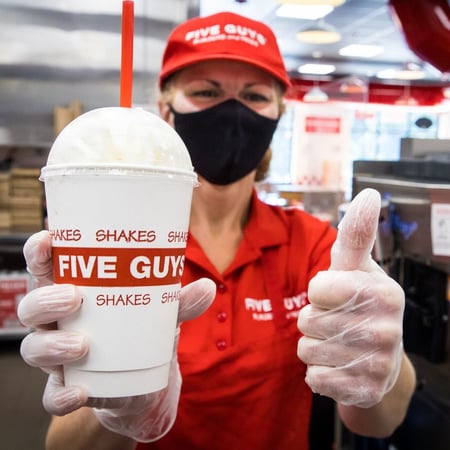 Five Guys employee with milkshake