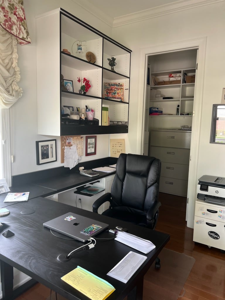 Home Office Custom home office with an L-shaped desk and overhead, glass cabinetry.