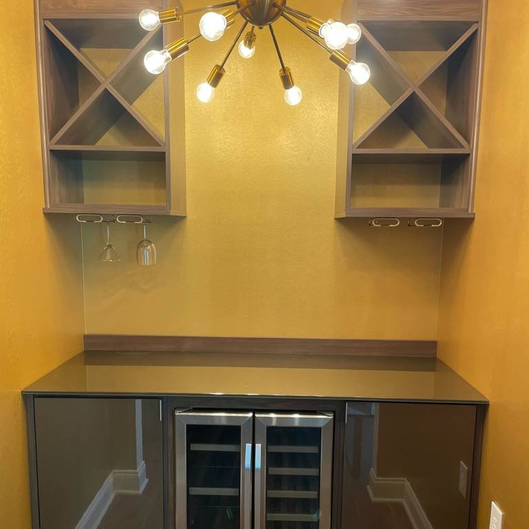 Wine Bar with Built-In Mini Fridge A wine bar complete with a mini fridge for convenient storage.