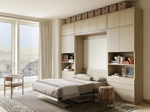 Benefits of a custom Murphy bed Wall bed with custom cabinets, desk and storage drawers in light wood finish, California Closets Gulfport & Hattiesburg Mississippi