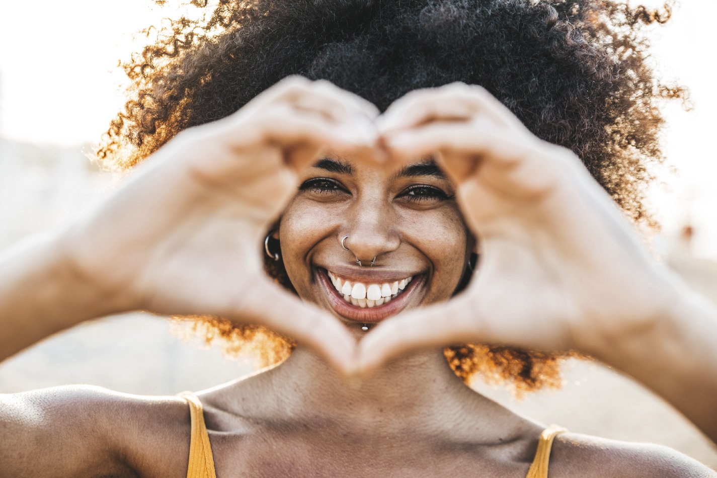 Woman creating a heart with her hands.