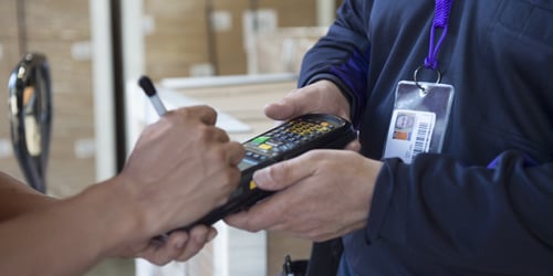 Customer signing for a FedEx Express package