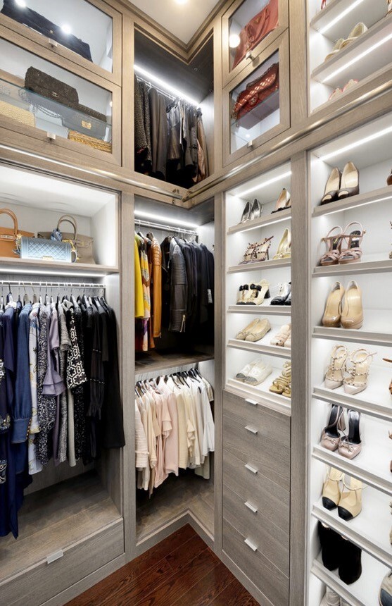 Glamorous Walk-in Closet floor to ceiling closet shelves with hanging space, drawers and lots of lighting in grey and white
