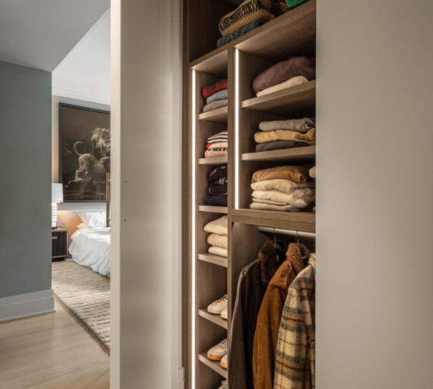 Hallway Closet brown reach-in closet with open shelving for folding sweaters, and hanging for clothing Manhattan New York
