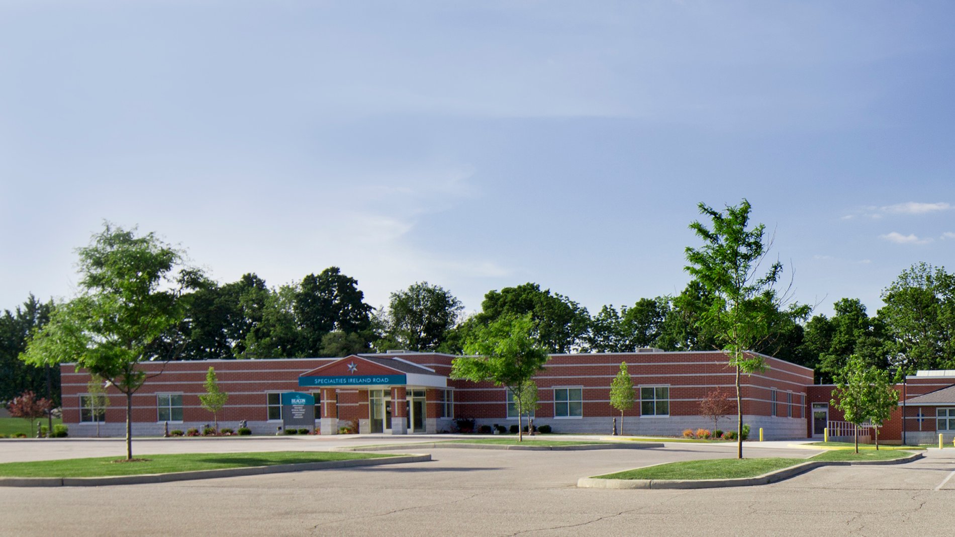 The Beacon Medical Group Ireland Road building with a teal sign for the entrance to specialty care.