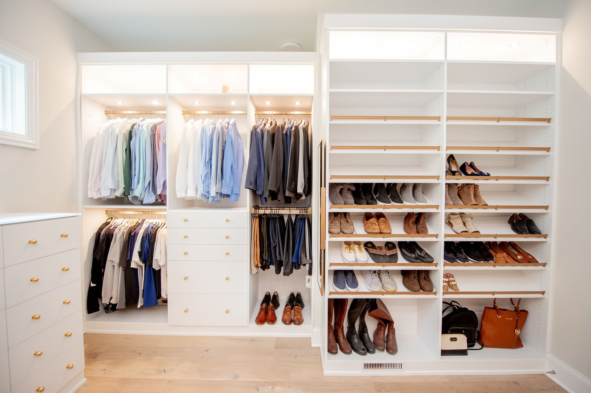 Walk In Closet Custom walk in closet with shoe storage and lighting to help with closet organization by California Closets Columbus in Columbus, Ohio