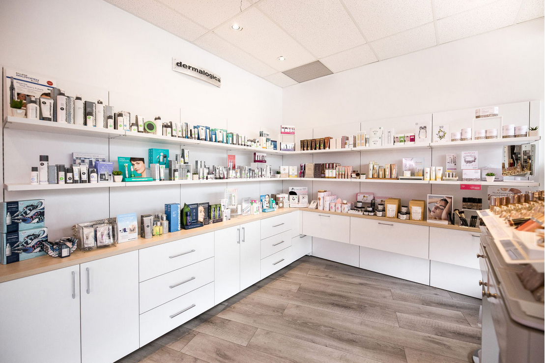 Custom built-ins for product display A large array of drawers and shelves used to display and storage skincare products in a retail location.
