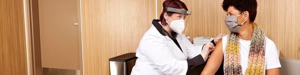 Pharmacist giving a lady a shot