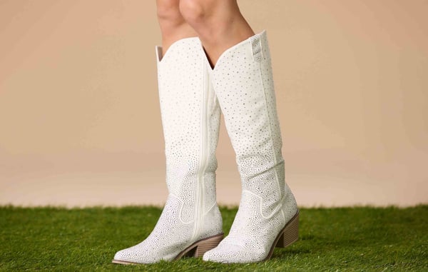 White tall cowboy boots with rhinestones.