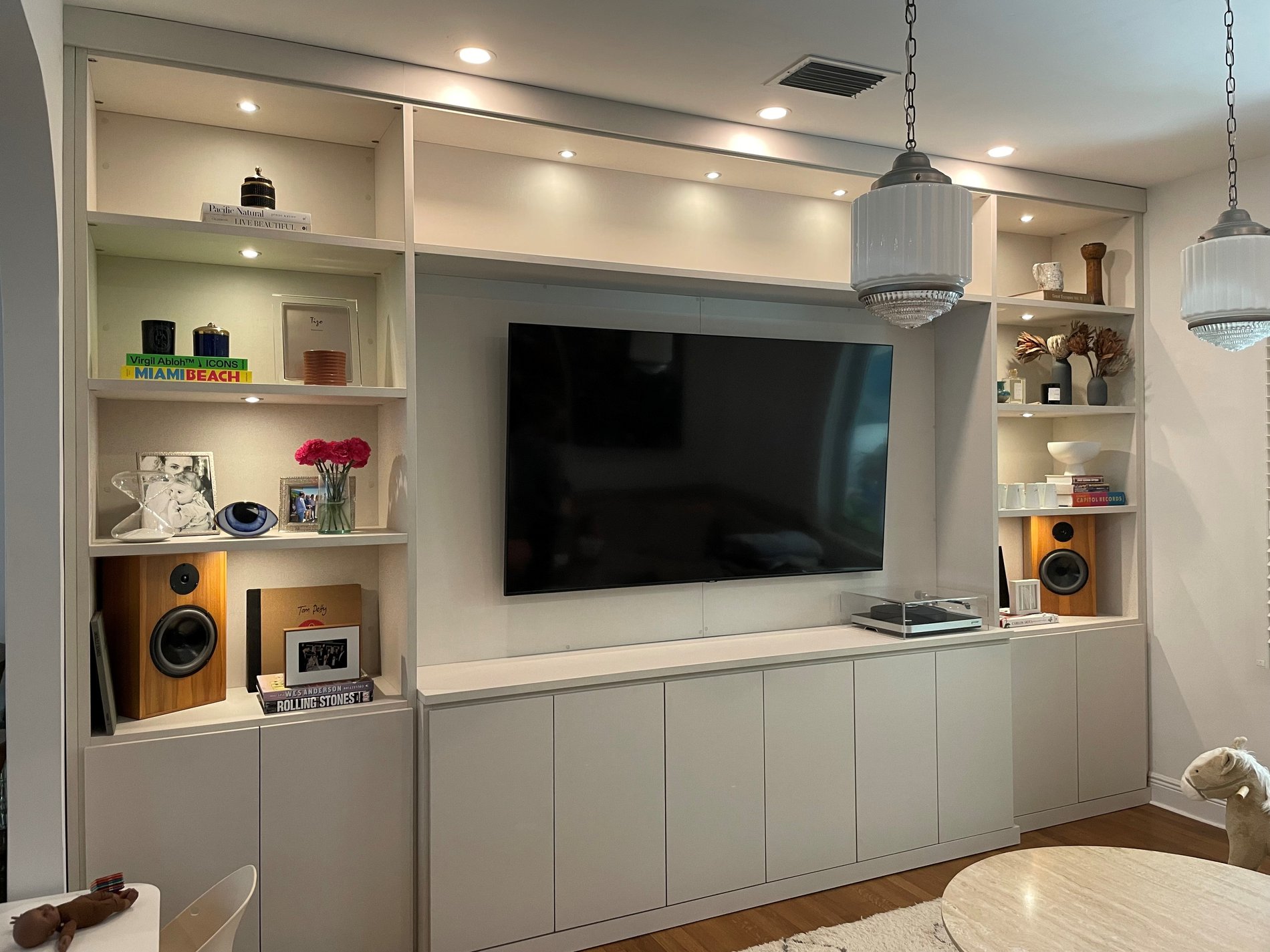 Media Center for the Whole Family to Enjoy Media Center with open shelving with some bottom hidden cabinets for those more valuable items.
