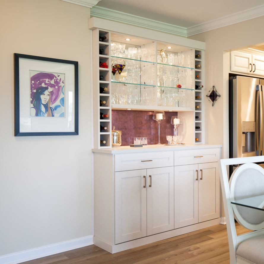 Design Consultant | Becky Caldwell Wine bar with decorative backing, glass shelves, accent lighting in Ocean City, MD by California Closets of Philadelphia and Delaware