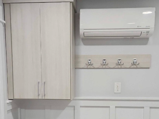 Have a place for everything! Upgraded mudroom space with hanging racks, wall cabinets and shelving by California Closets Myrtle Beach, South Carolina.
