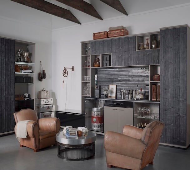 The Ultimate Garage Retreat Garage cabinets with custom storage, glass shelving, built-in beverage fridge and bar area for an organized garage entertainment space. California Closets, Greater Detroit