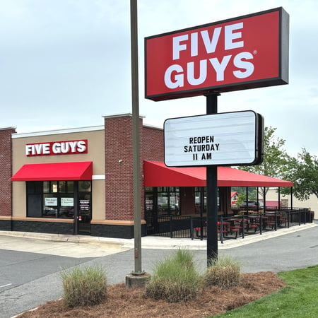 Exterior photograph of the Five Guys restaurant at 2212 East Franklin Boulevard in Gastonia, North Carolina.