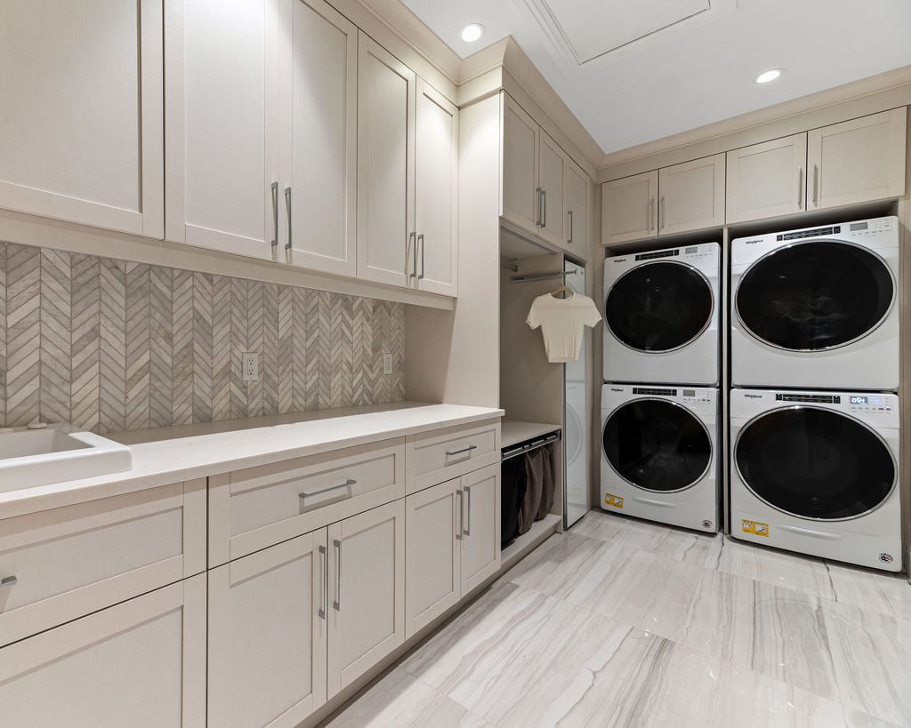 Custom Laundry Room Pantry with chevron backsplash and duel stacked Washer and Dryer by California Closets Northern Michigan