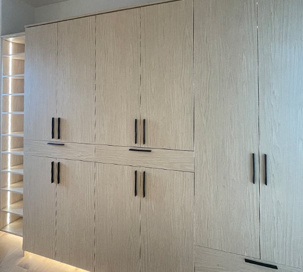 Walk In Closet Cabinets | California Closets Pasadena Walk-in closet with lit glass shelving by California Closets Pasadena.