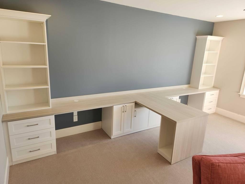Double Desk Office with Bookshelves and Storage Drawers A double desk office space with bookshelves and drawers for storage.