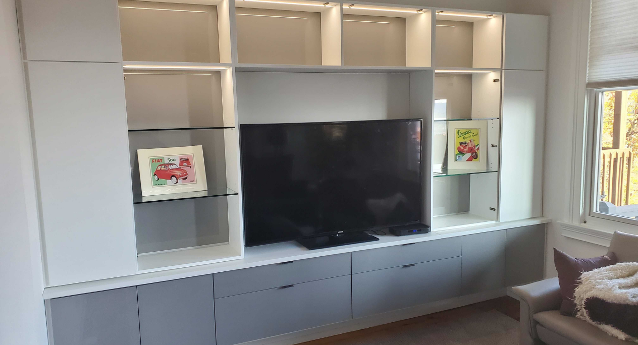 Entertainment Center Entertainment center with lighted shelving and drawers.