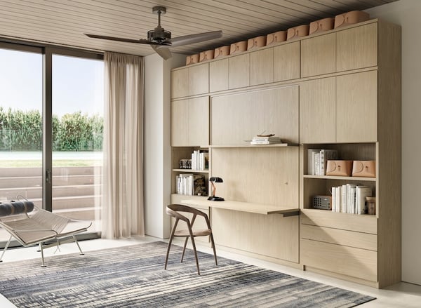 Murphy bed with desk, shelves, and cabinets in light wood by California Closets Northern Michigan